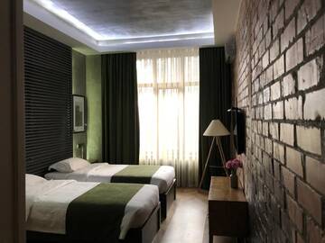 Фото номера Бюджетный двухместный номер с 2 отдельными кроватями Отель Bugu Hotel Bishkek г. Бишкек 8